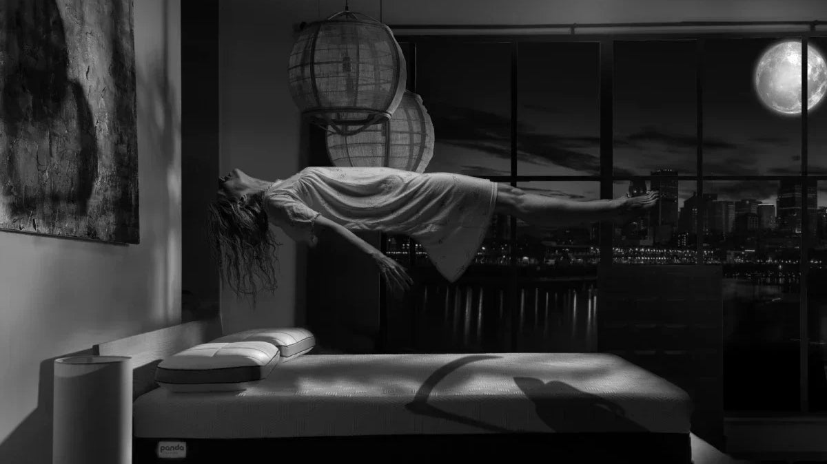 Halloween image of a girl floating over a Panda Mattress like it is haunted
