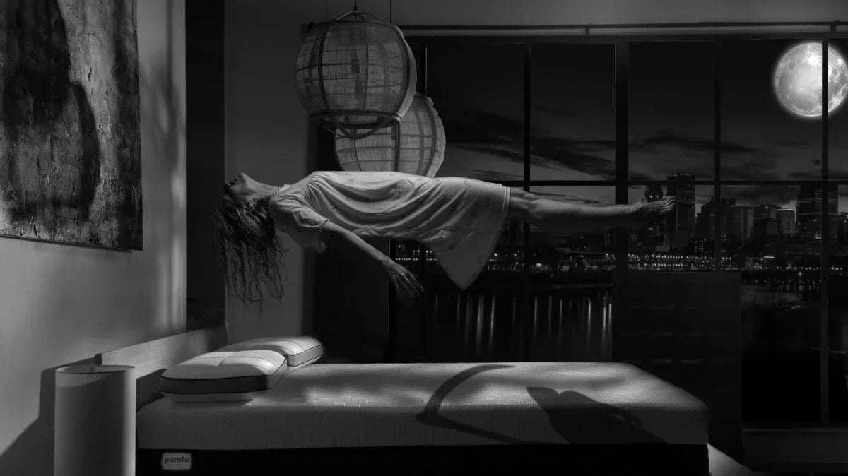 Halloween image of a girl floating over a Panda Mattress like it is haunted