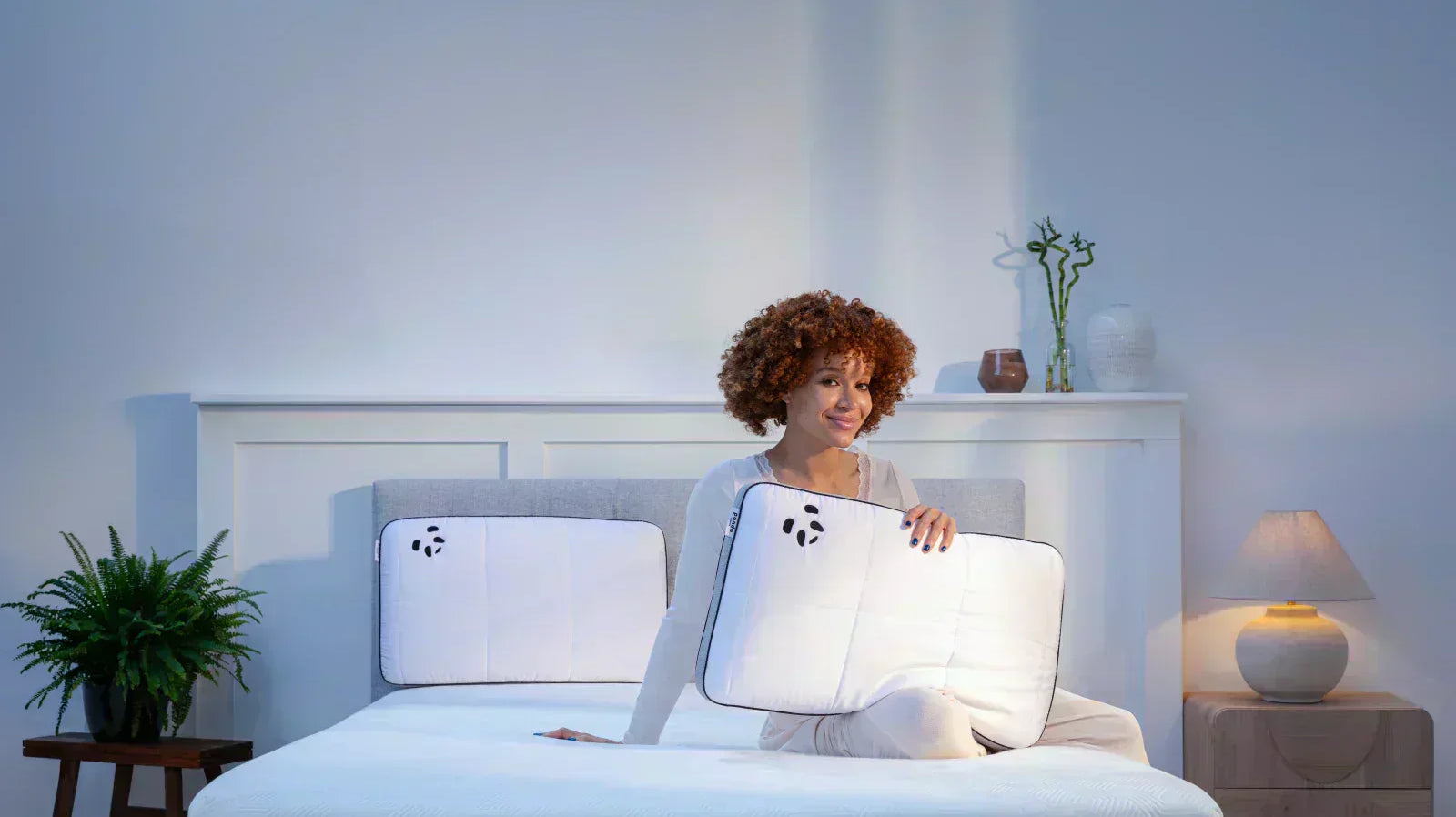 Woman with Panda Hybrid pillows in bedroom.