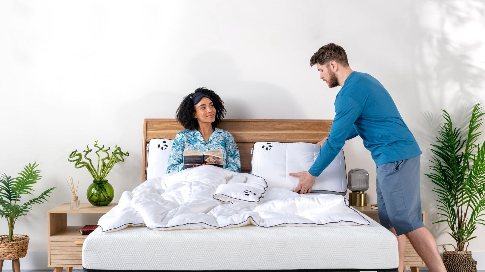 Couple preparing the bed for sleep