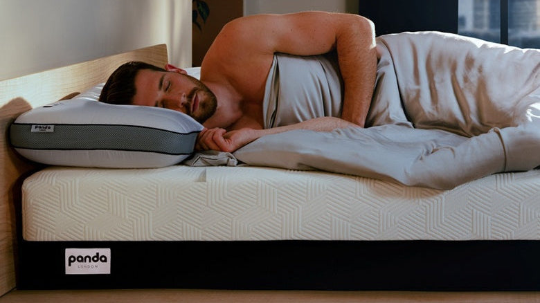 Man peacefully sleeping on a Panda mattress, demonstrating relaxation and comfort for quality sleep.