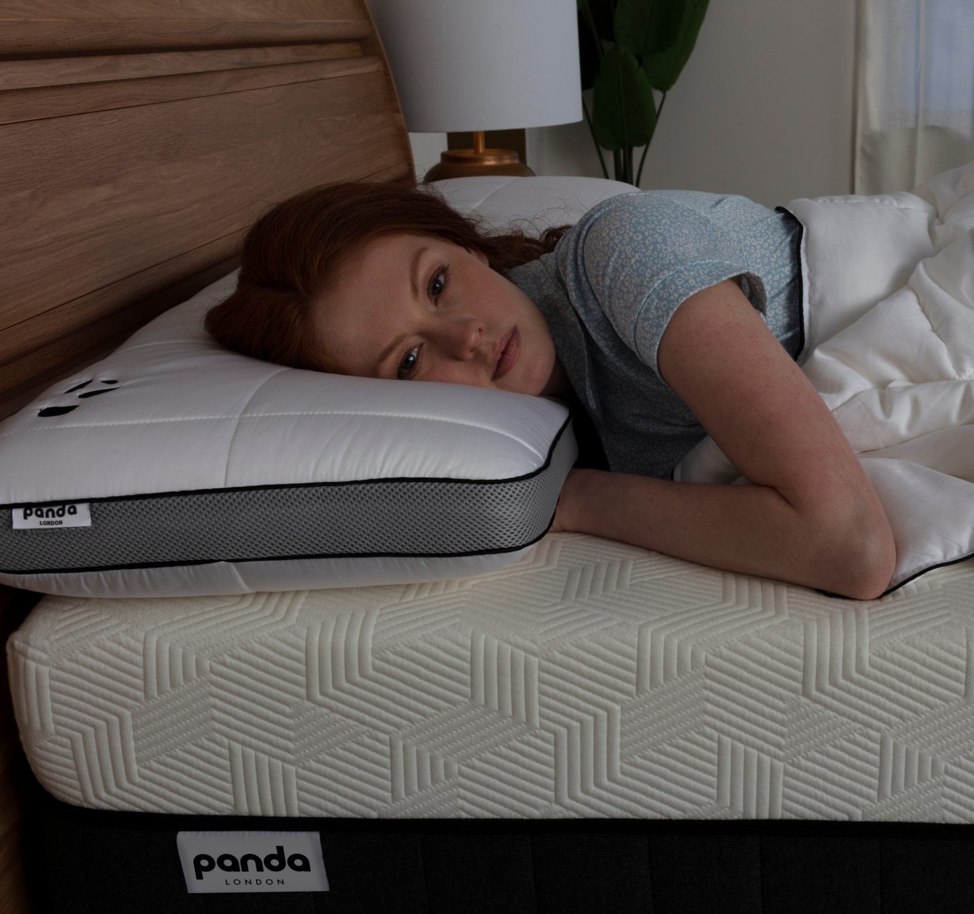 Woman lying on a Panda London mattress, showcasing comfort for quicker sleep.