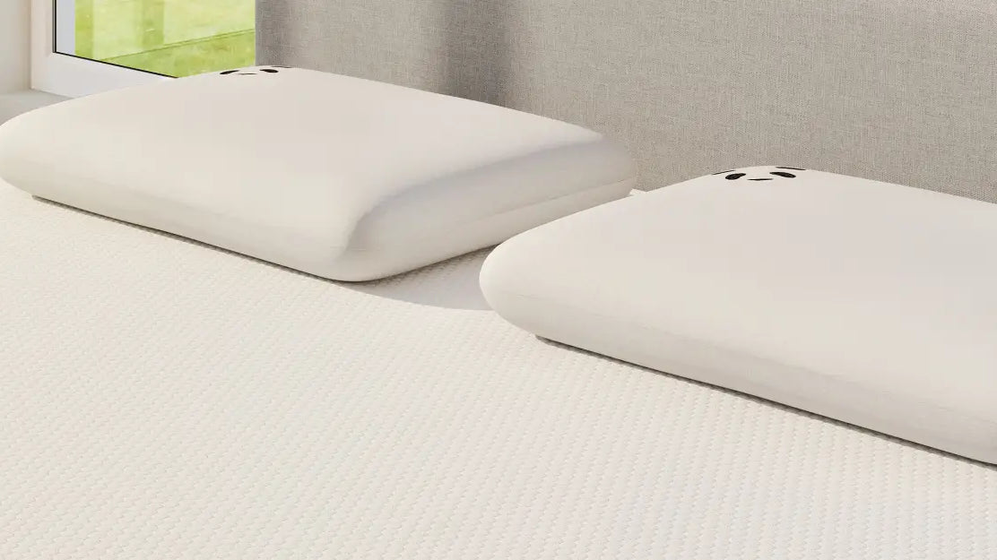 Two plush pillows on a bed, showcasing comfort and style for better sleep quality.