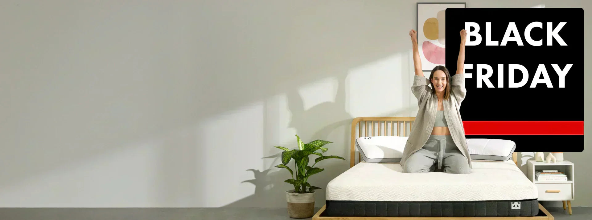 Woman on the Panda Hybrid Mattress Pro with Black Friday Logo above her