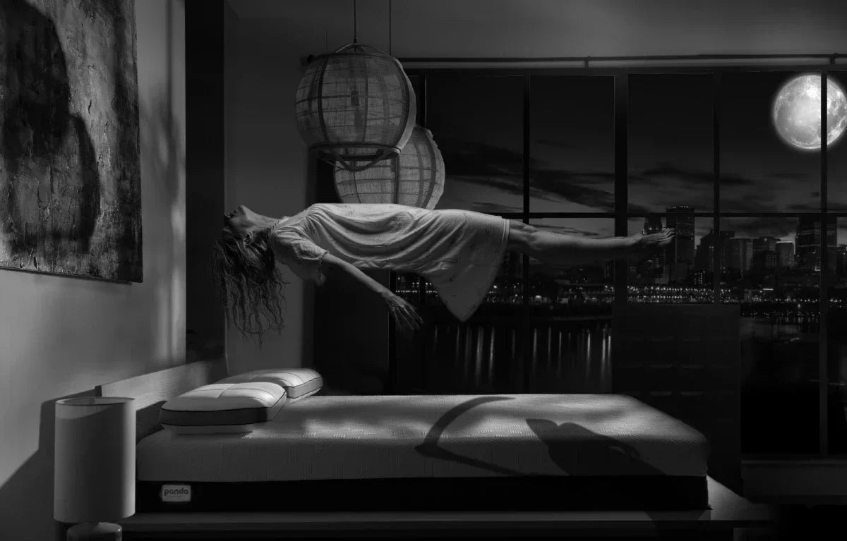 Halloween image of a girl floating over a Panda Mattress like it is haunted  
