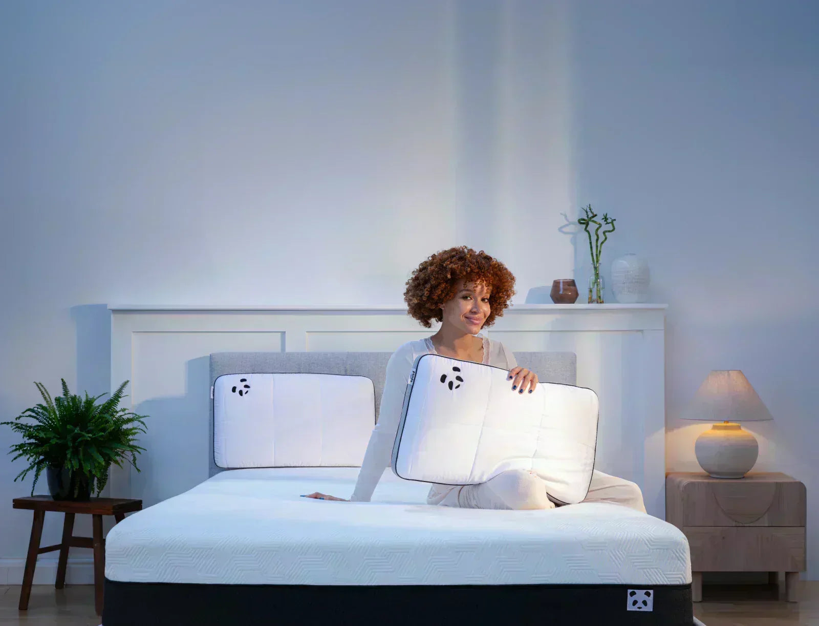 Woman with Panda Hybrid pillows in bedroom.