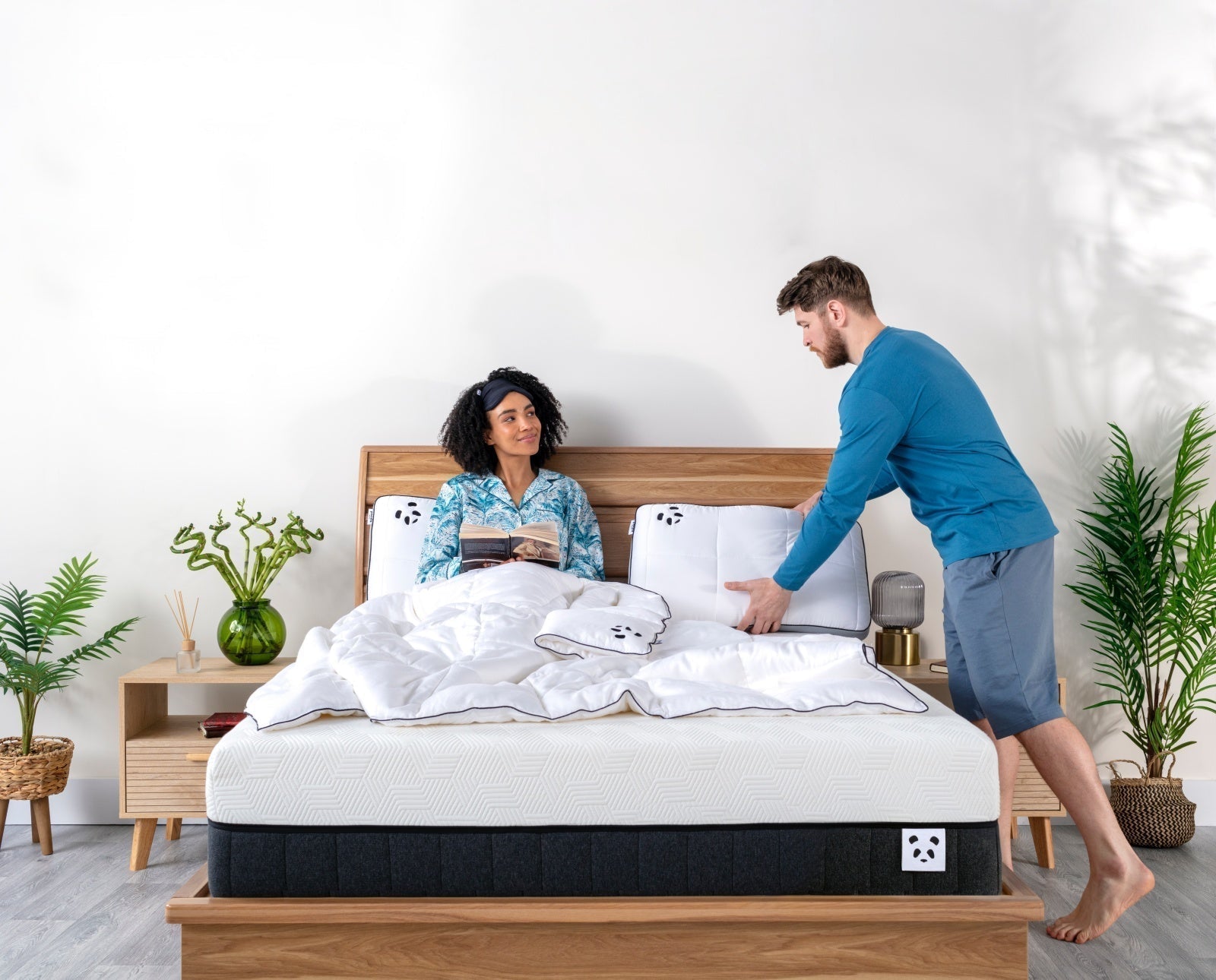 Couple preparing the bed for sleep