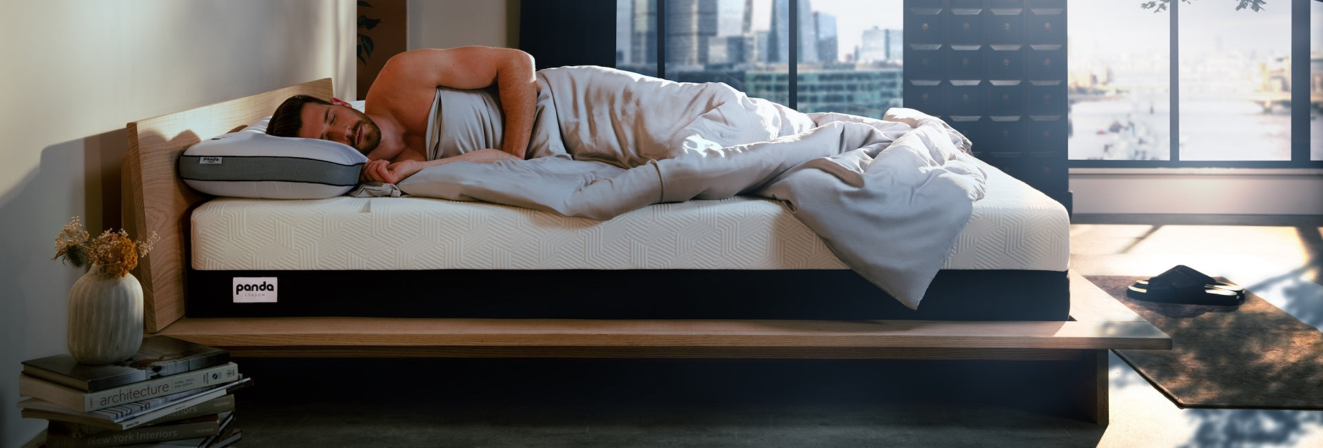 Man peacefully sleeping on a modern mattress in a cozy bedroom, showcasing sleep tracking technology.