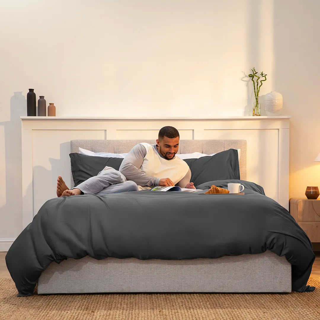 [BBUrbanGrey] 100_Bamboo_Bedding_Set_Urban_Grey_guy laying on the bedding