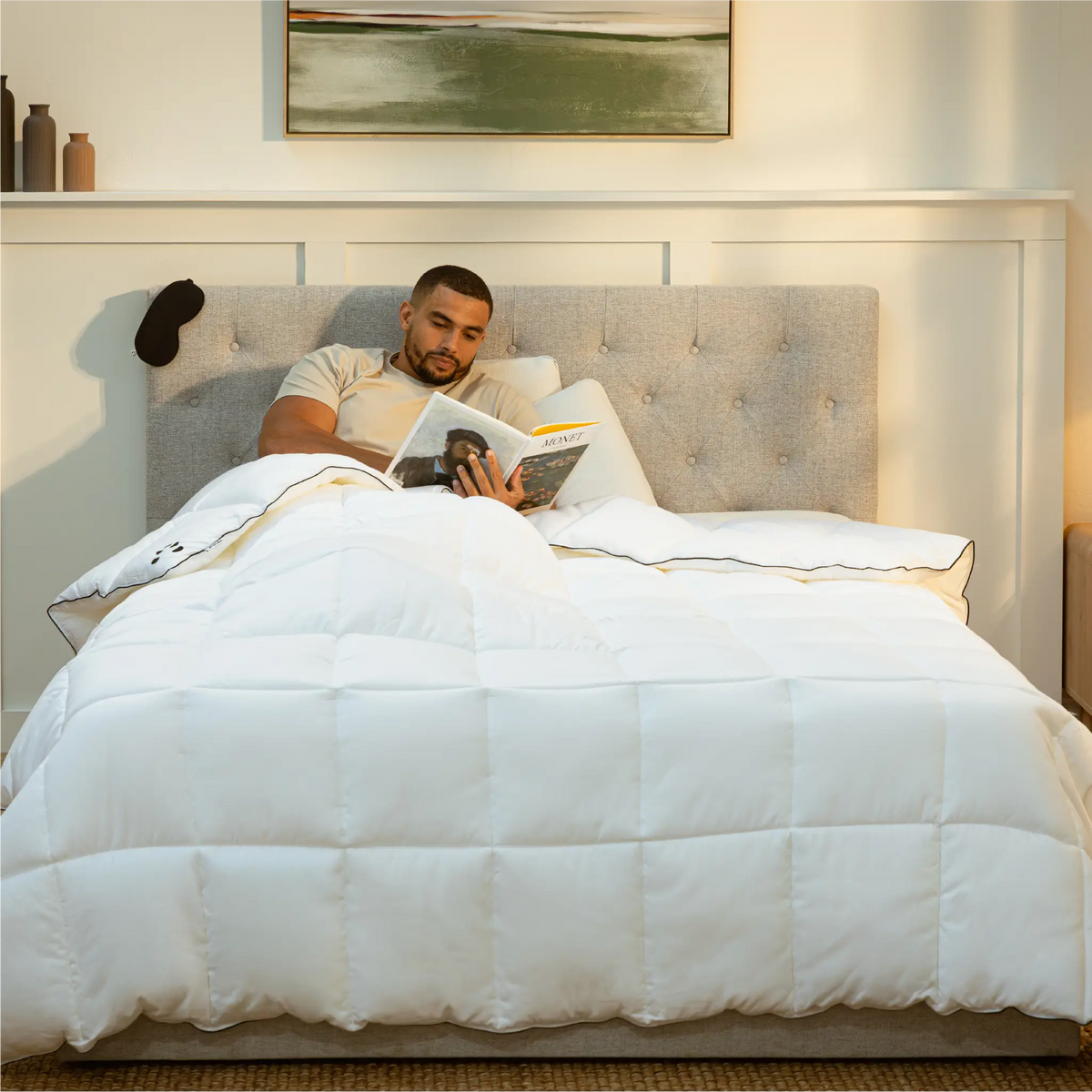 [CloudDuvet] Guy reading a book on the bed covered with Panda Cloud Duvet 10.5 TOG