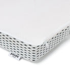 [all] Close-up of a Hybrid Mattress Topper showcasing breathable mesh design and corner label.