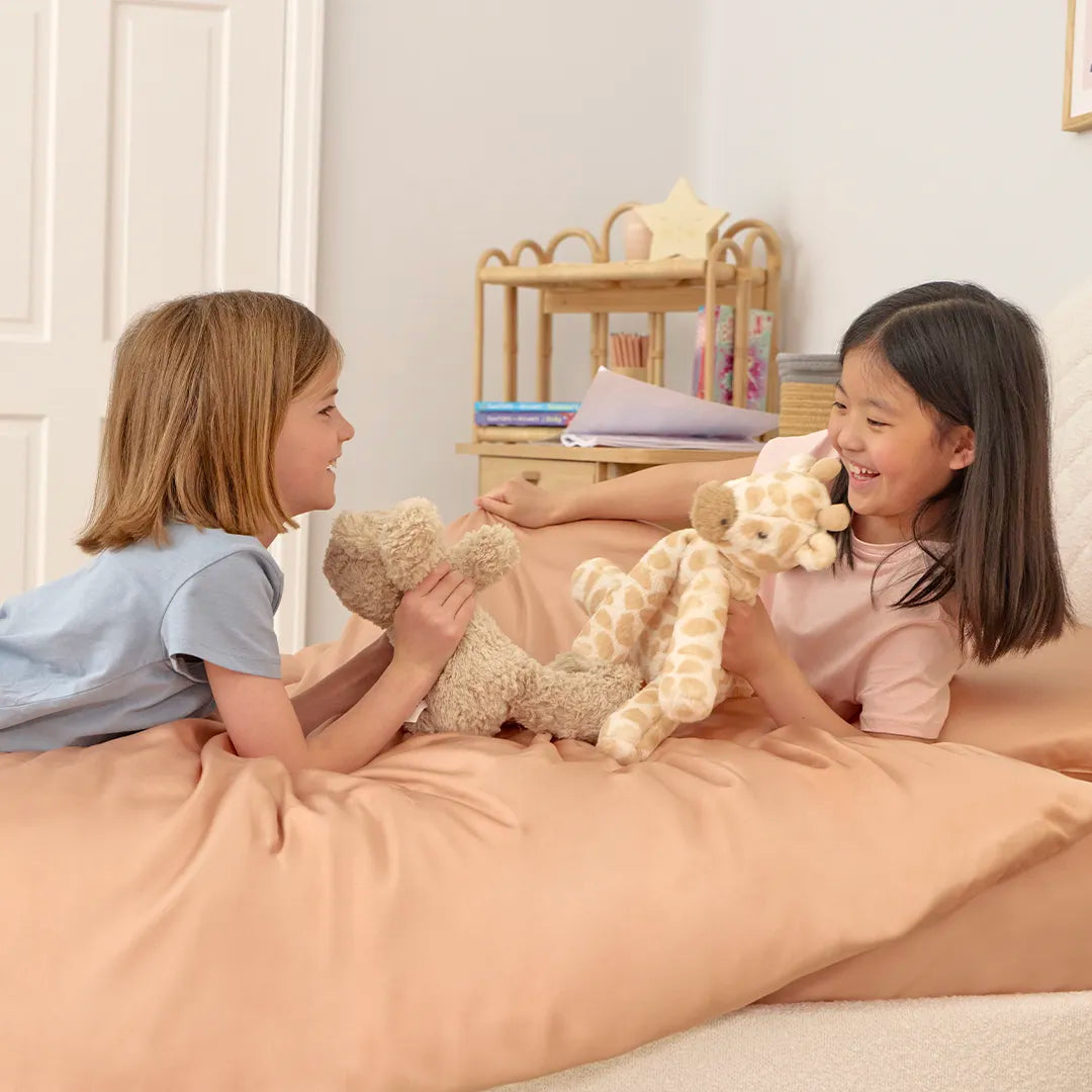 [FSKidsP] Girls playing and laughing on a Kids Bamboo Bedding Set Pink