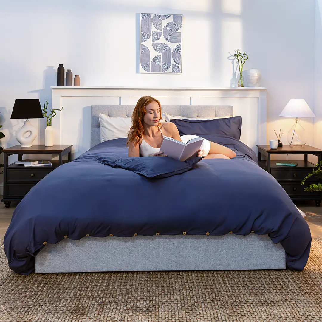 [MidnightNavy] Woman reading a book on a Bamboo and French linen bedding set