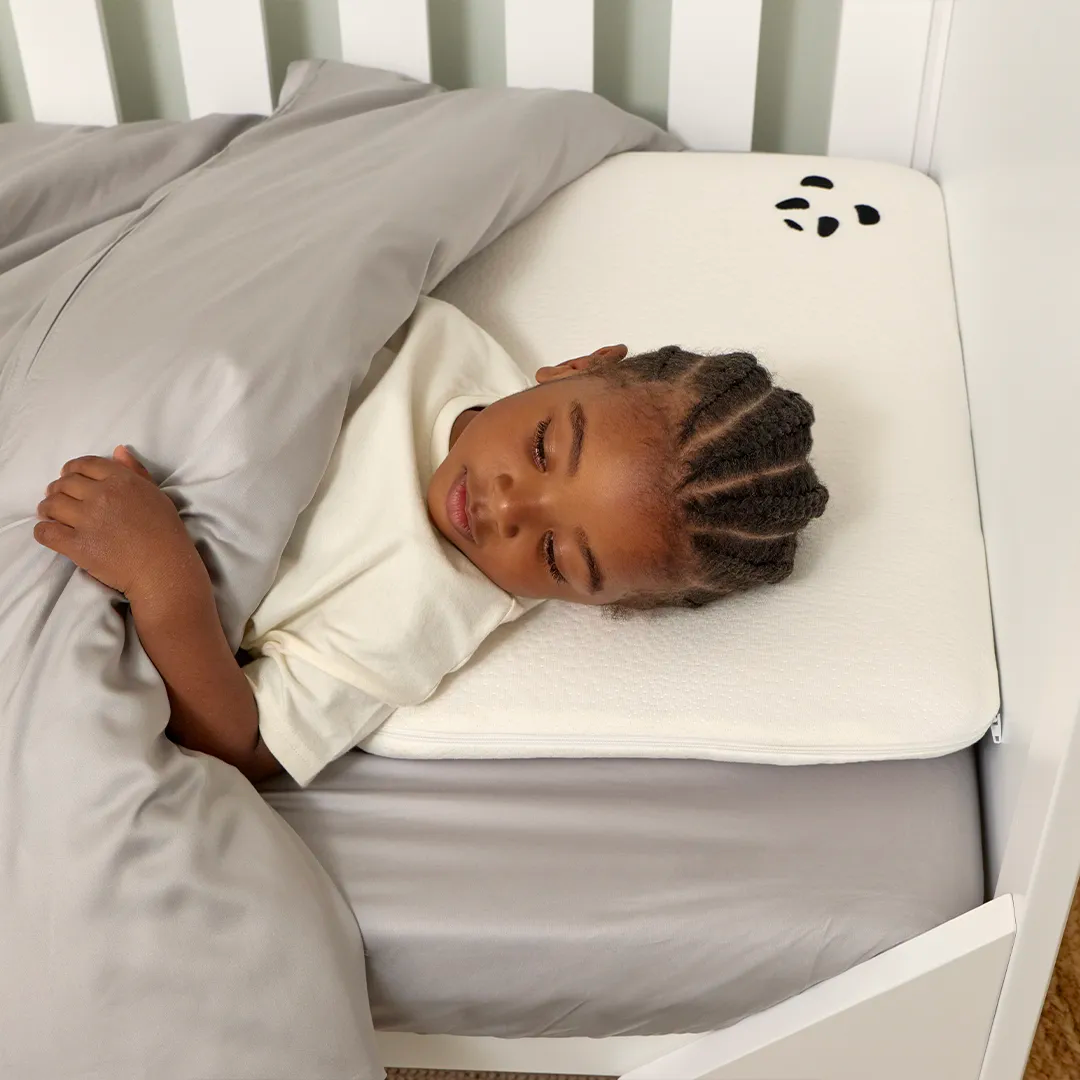 Boy laying on a Toddler Bamboo Panda London Pillow