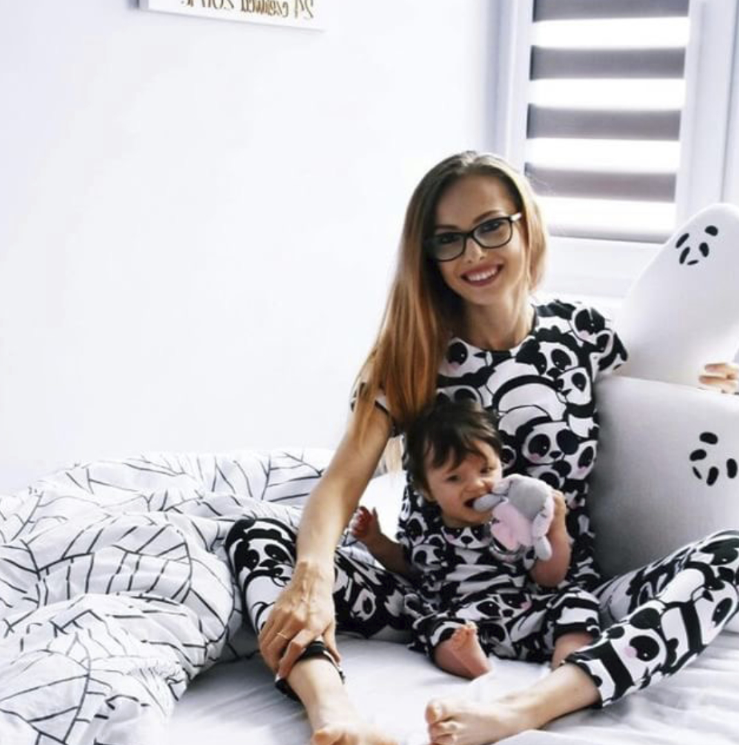 Mom and baby with Panda Pillow on the bed