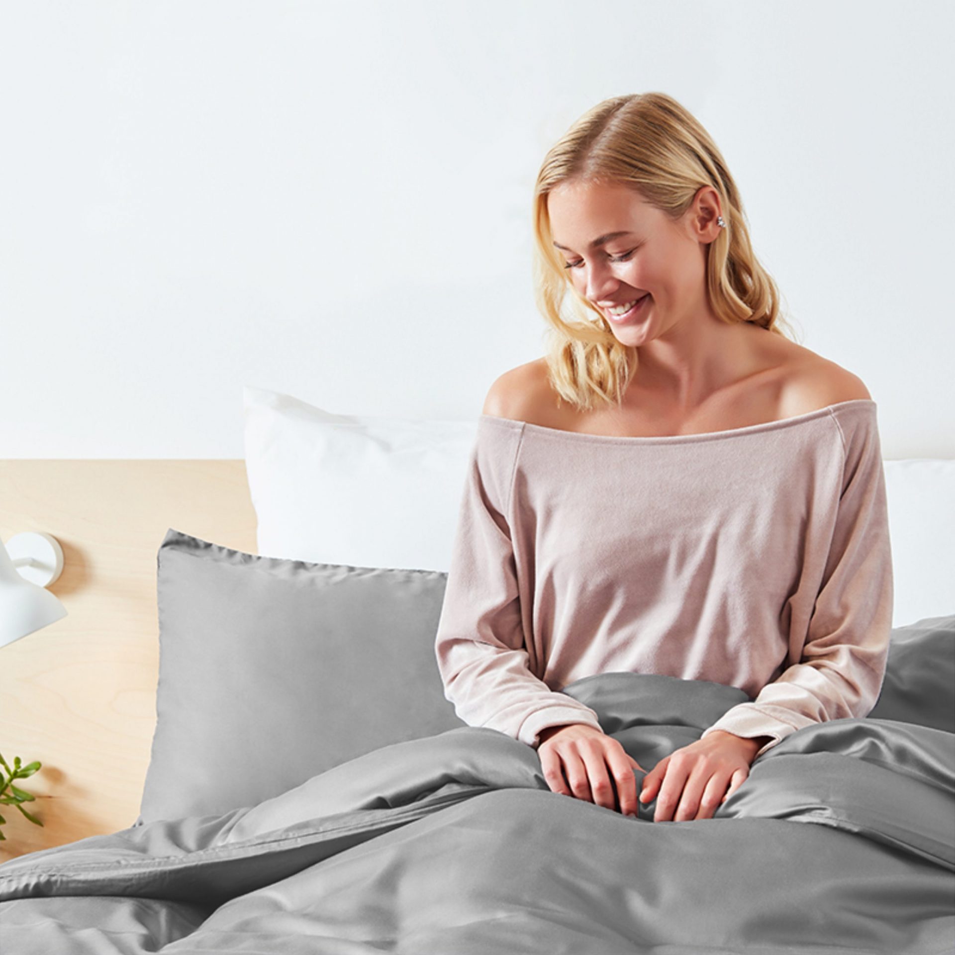 Woman Smiling In Bed With Panda London 100 Bamboo Bedding Quiet Grey