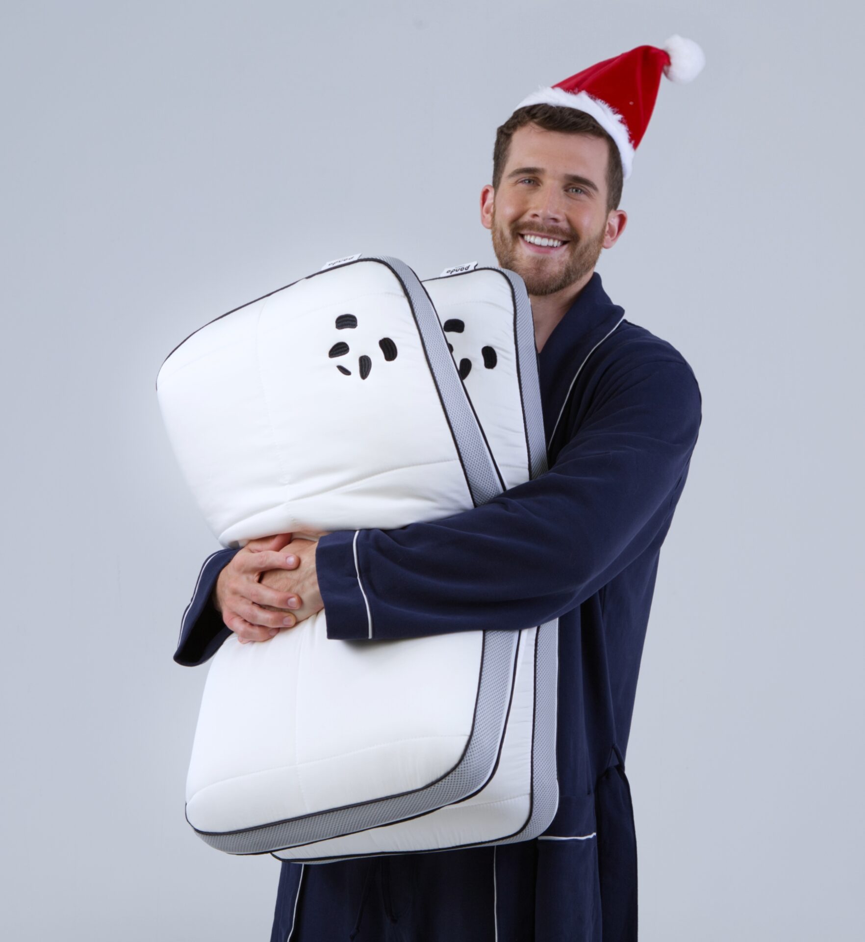 Guy with santa hat holding Hybrid Bamboo Pillows