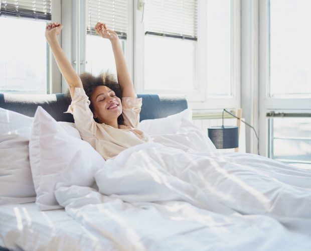 woman streching on the bed in the morning